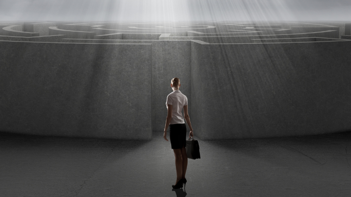 Image of woman standing at the entrance to a maze - the COVID-19 crisis can feel like a confusing maze